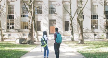 a couple of people that are standing in front of a building