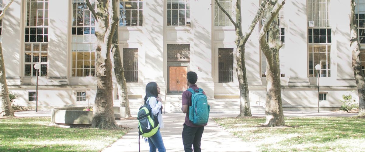 a couple of people that are standing in front of a building